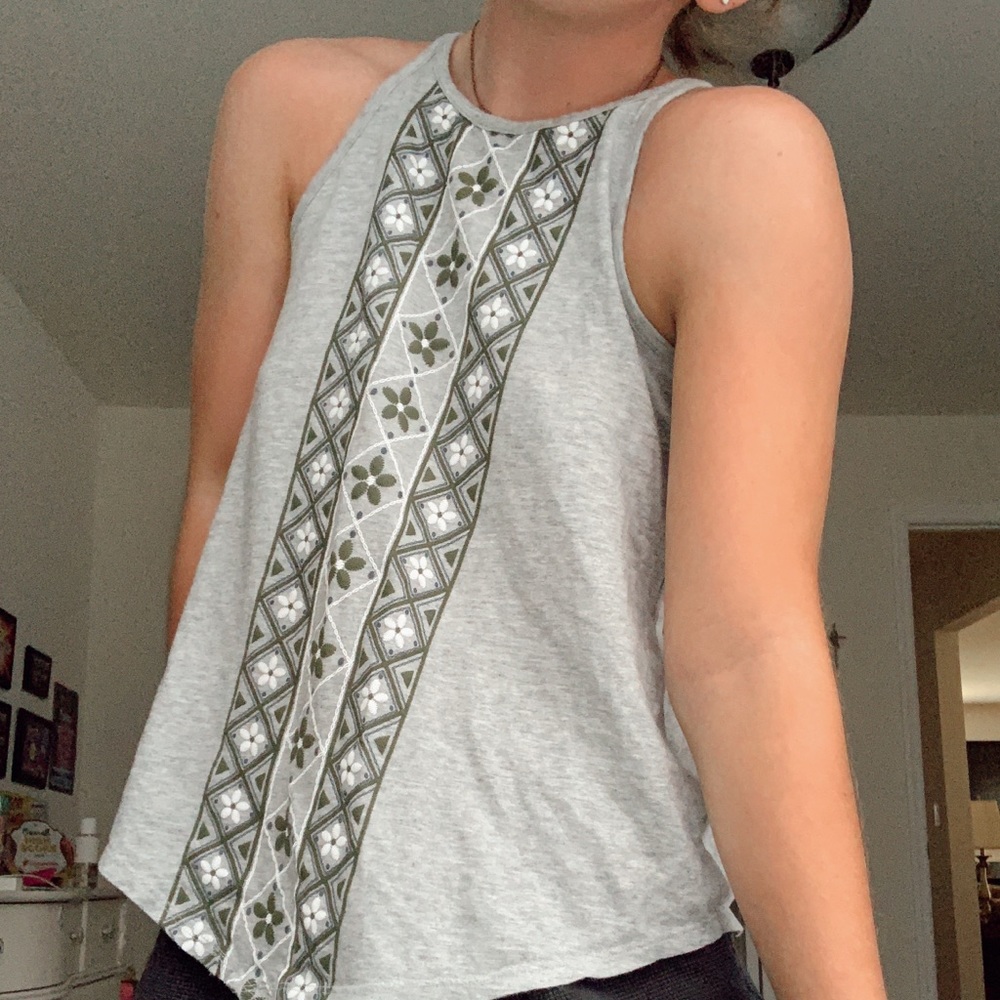 Gray tank with green print in center